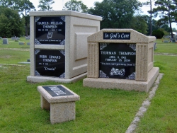 Over-and-under basic mausoleum and a single deluxe mausoleum with fluted columns and a bench in Pascagoula, MS